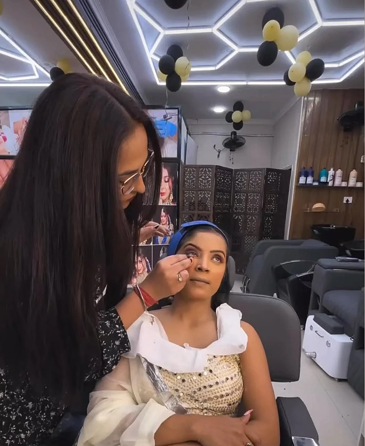 Twinkle Arora performing eye makeup makeover inside the Dwarka Mor salon studio