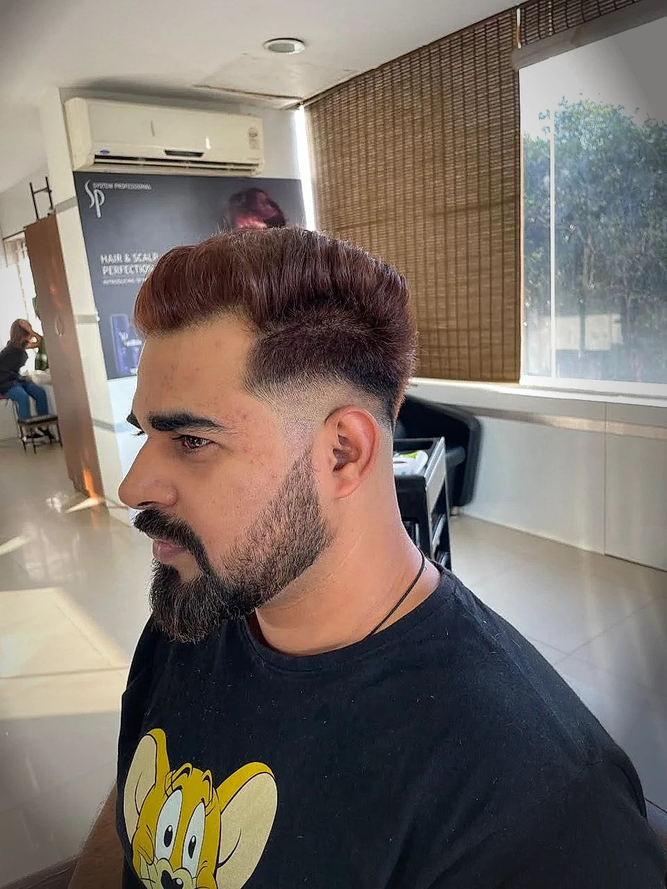 Precision men’s skin taper fade haircut and beard sculpting by professional barber